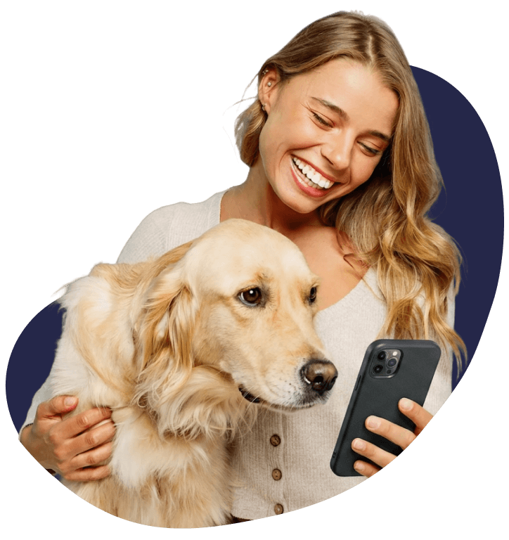 Dog owner with her golden retriever, booking a sitter on her phone
