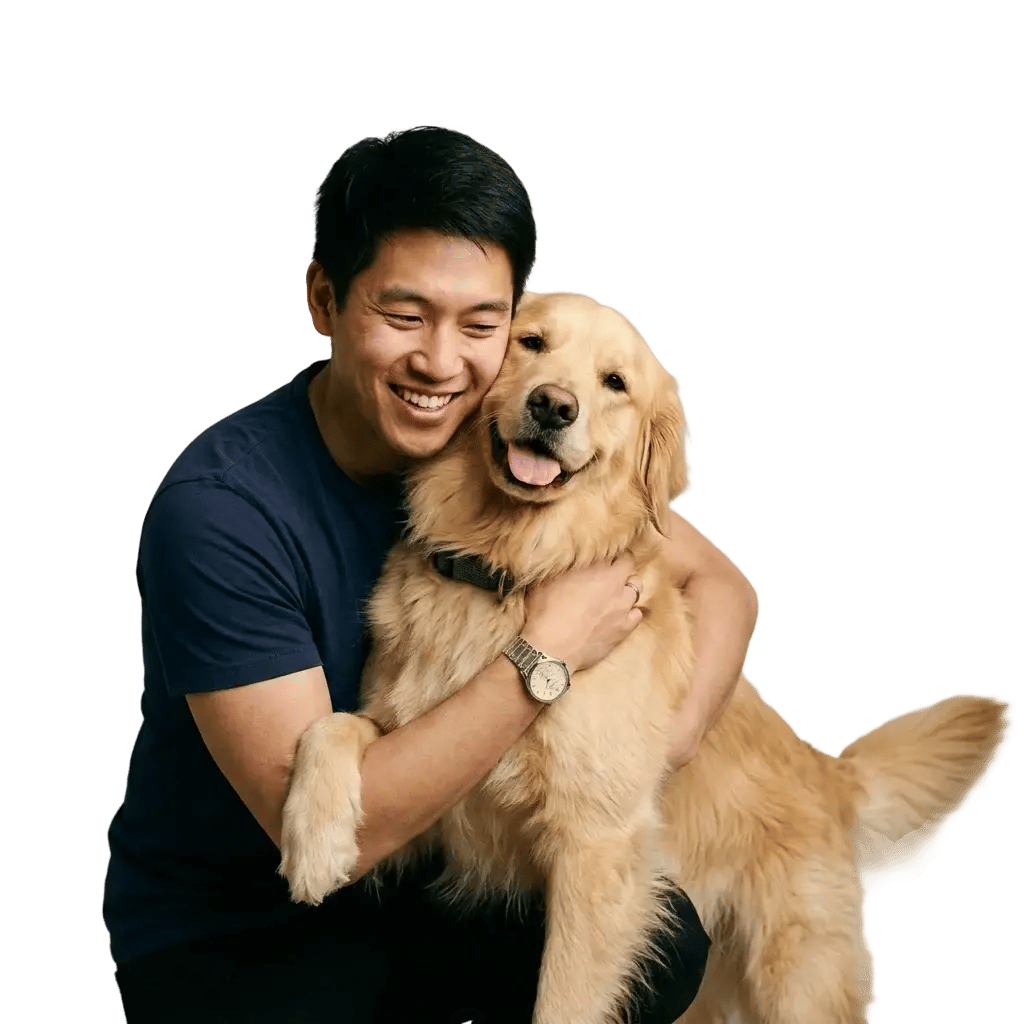 Happy dog parent hugging a Golden Retriever